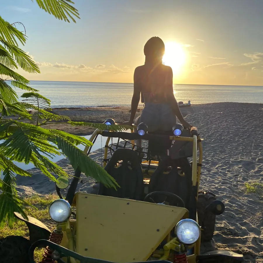A rider on a dune buggy watching the sunset at Mero Beach