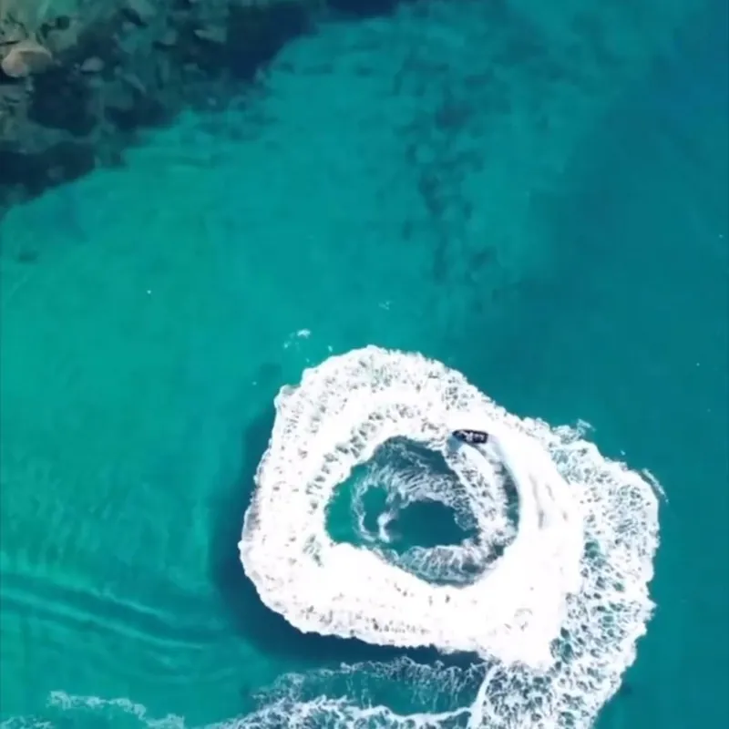 Jet ski carving a circle, seen from above
