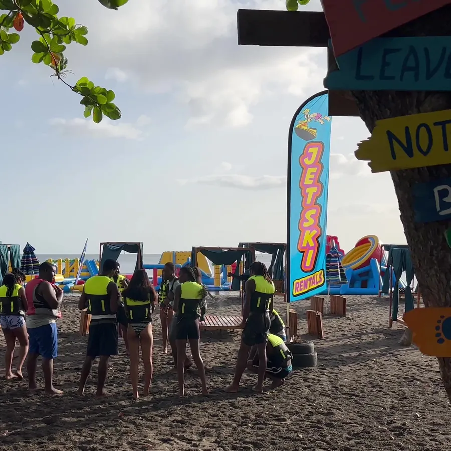The Jungle Carts base on the sand, flags up and guests waiting