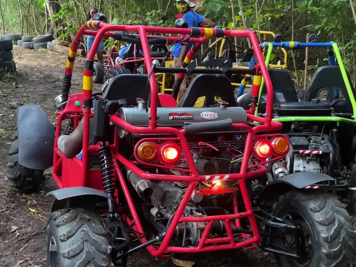 A Jungle Carts buggy at the trail head, lights on