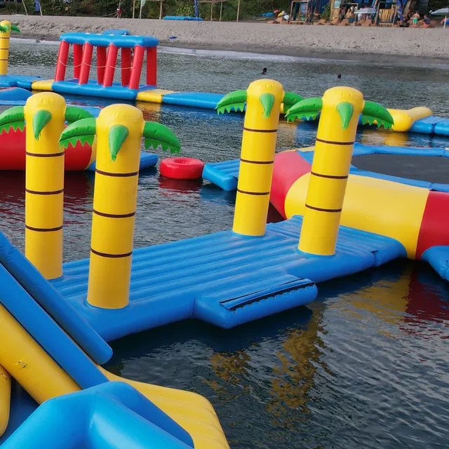 Trampolines and palm obstacles on the far side of the park